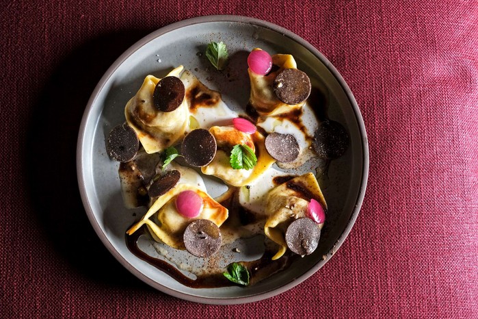 A truffle dish beautifully presented on a grey plate